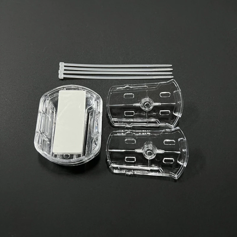 Mounting kit contents: adhesive base, attachment plates, and cable ties