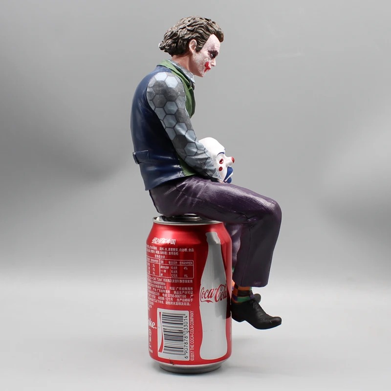 Side profile of the seated Joker figure
