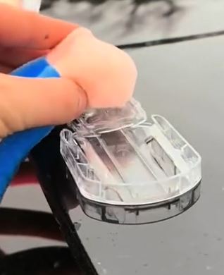 Pressing the adhesive mounting base onto a car body