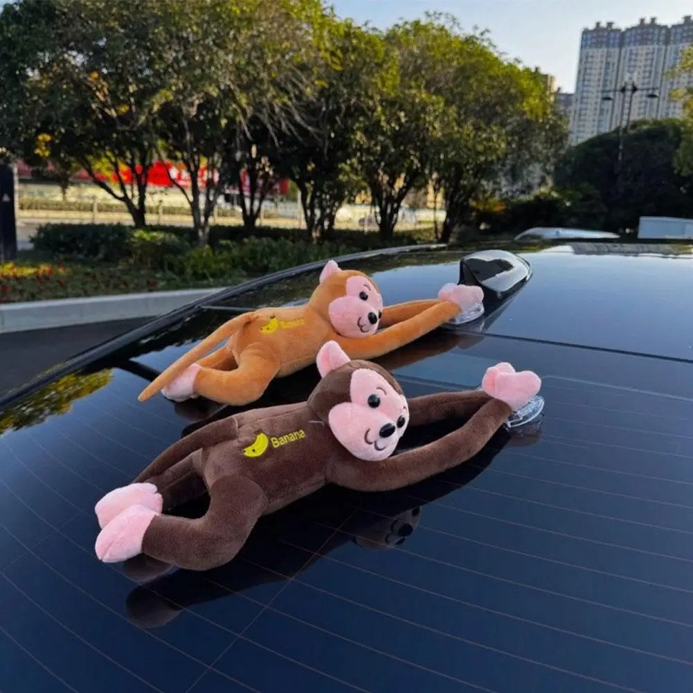 Orange and brown monkey ornaments on a car roof